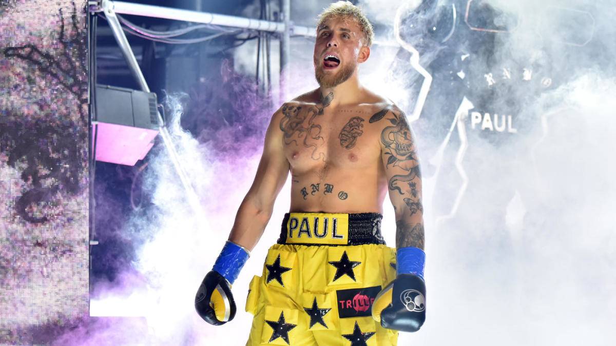Jake Paul standing in boxing arena and boasting